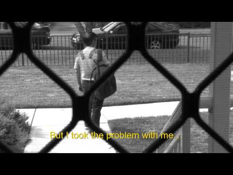 Looking through a screen door at a man walking down the footpath