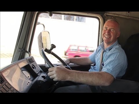 Man sitting in the drivers seat of a truck