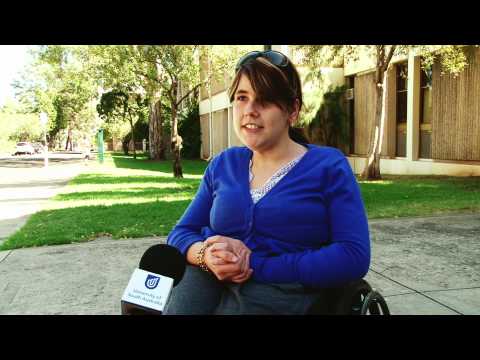 Young lady in a wheelchair sitting outside on the footpath