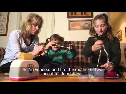 Mother sitting on the lounge playing with 2 daughters