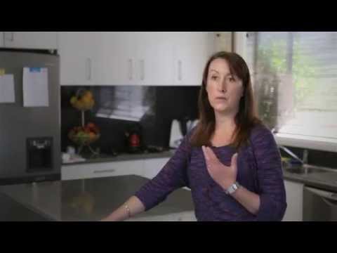 Lady standing in kitchen speaking