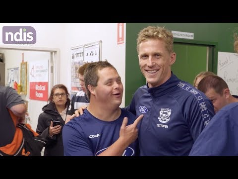 Picture of men in a football locker room chatting and laughing