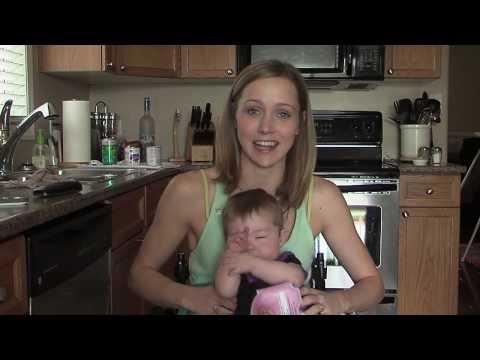 Young woman sitting in a wheelchair holding her baby