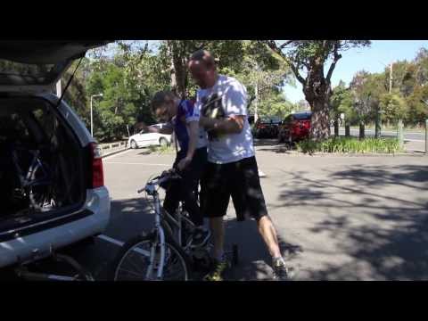 Man lifting his son off a bike