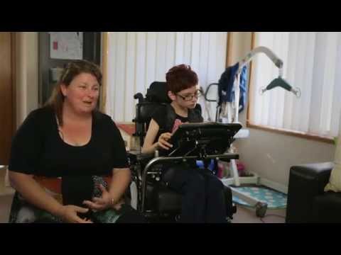 Lady girl in a wheelchair sitting next to her mum