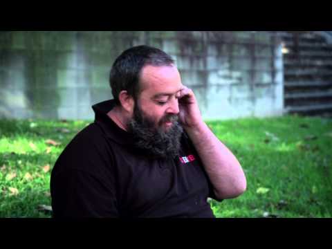 Man sitting on the grass talking on a mobile phone