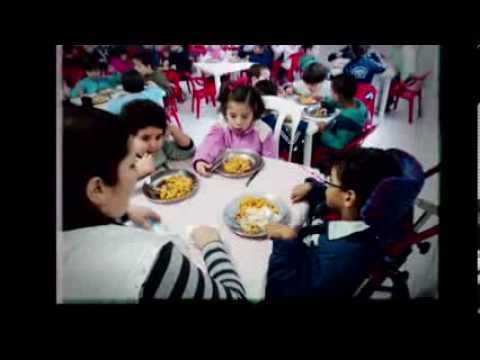 Children sitting at a table eating