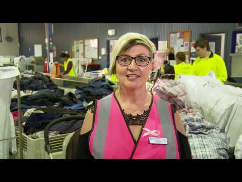 Lady in pink hi vis top in a factory