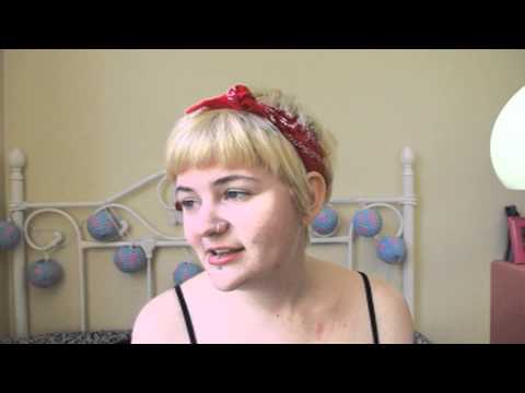 Young lady sitting on her bed