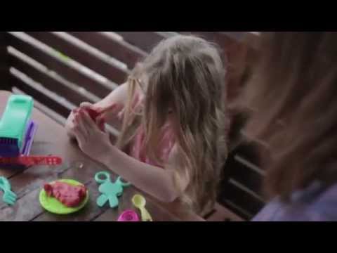 Young girl playing with toys at a table