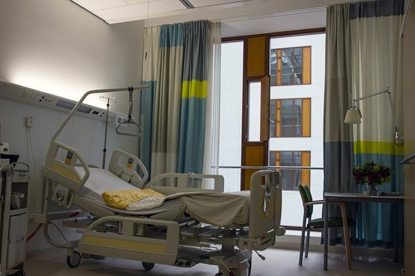 The room where Philip spent his recovery with hospital bed, bright curtains.