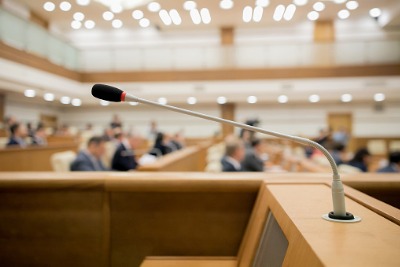 Image of a microphone at a lectern in a formal inquiry chamber