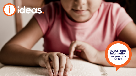 Young girl reading a book in braille