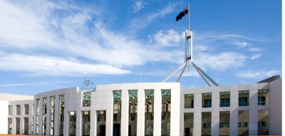 Exterior shot of Parliament House, Canberra with Australian Flag flying above