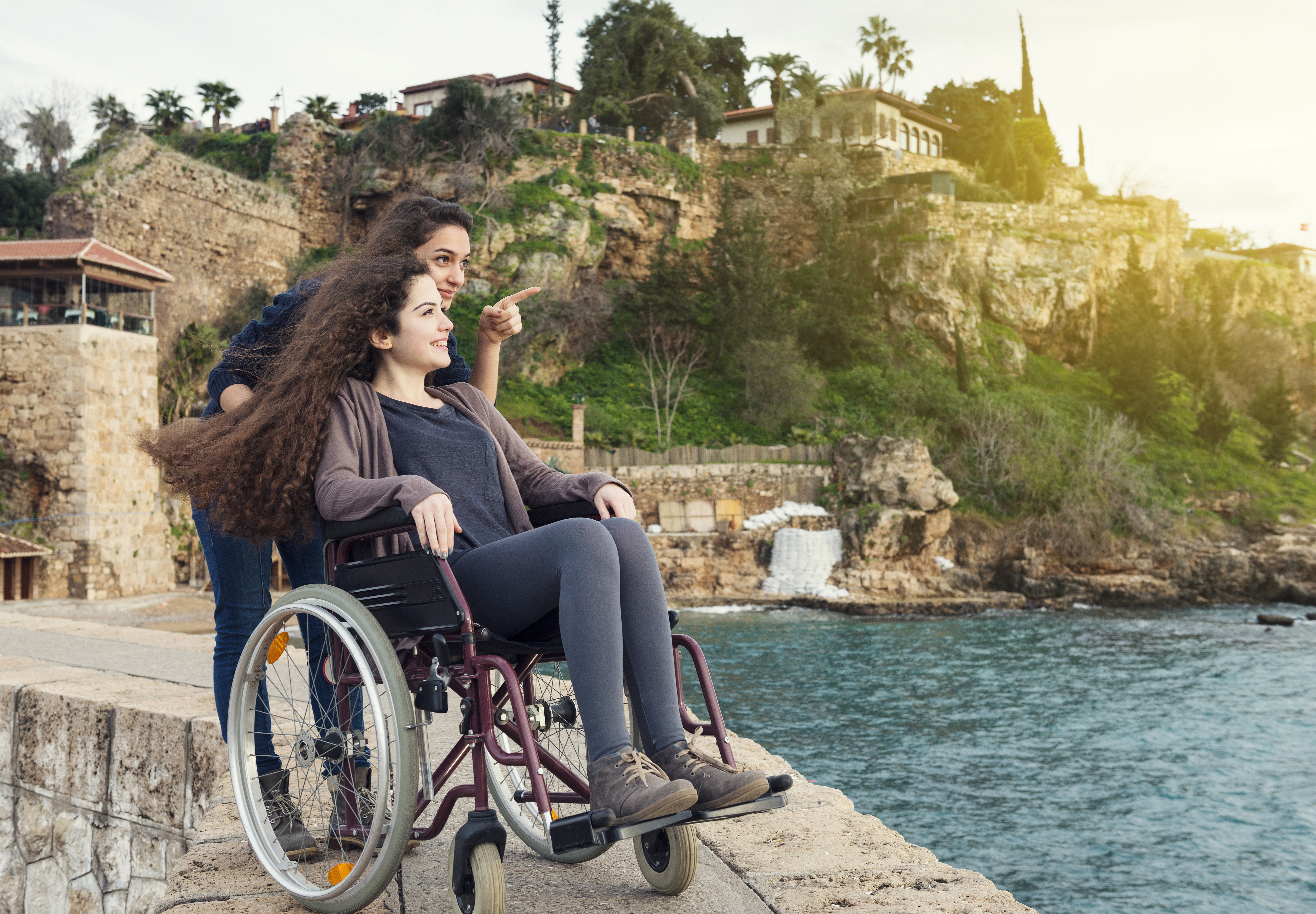A woman in a wheelchair and her companion looking and pointing at something