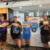 A group of people holding the food they have cooked.