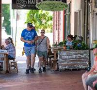 Dan walking past a cafe-cropped