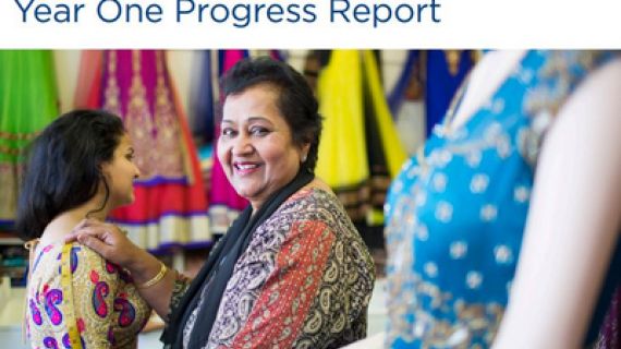 Lady measuring arm length of a young woman