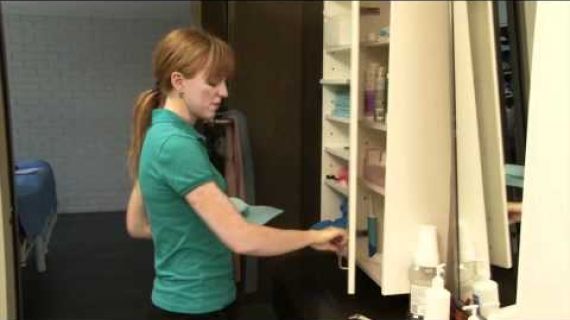 Lady standing at a medical supply cupboard
