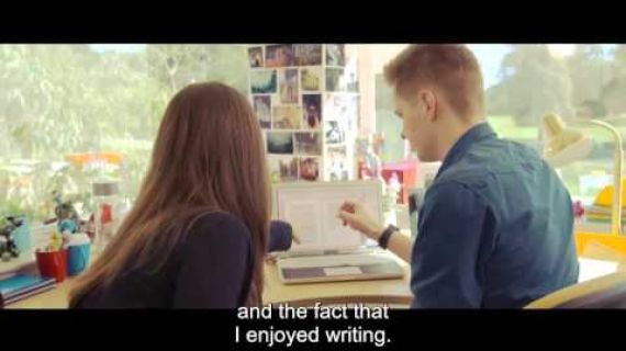 People sitting at a computer looking at the screen