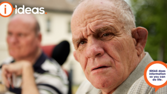 A man with intellectual disability looks toward the camera