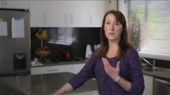 Lady standing in kitchen speaking