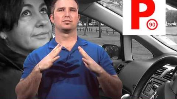 Man signing with a red P plate on the screen
