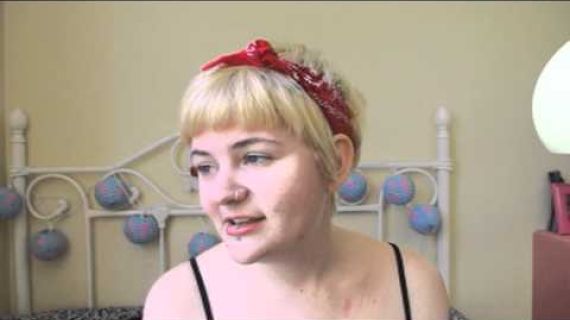 Young lady sitting on her bed