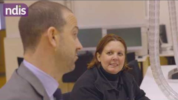 Man sitting next to a woman