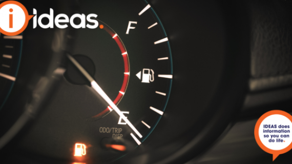 An image of a car dashboard, close up of the Fuel Gauge, which is showing empty and the fuel indicator light in on.