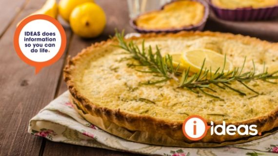rosemary cake with sprigs of romsemary and slices of lemon