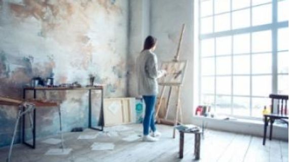 Young woman artist painting