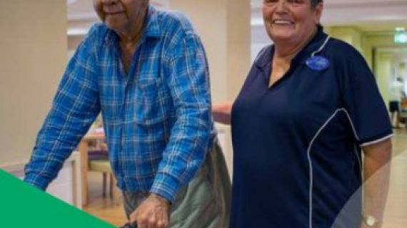 Man with a walker and a lady standing next to him
