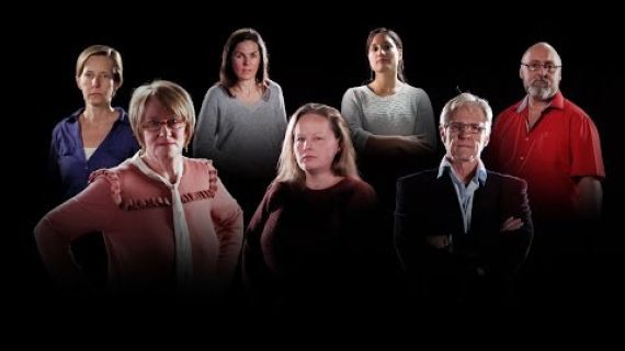 Group of people standing in a dark room