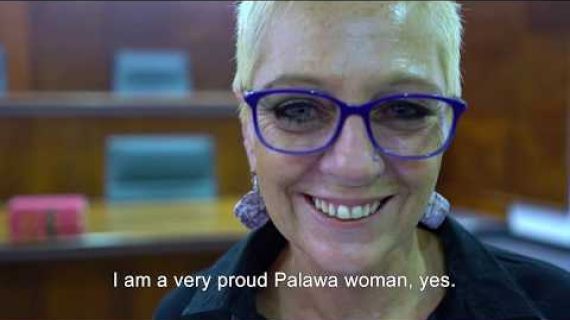 Lady with blue glasses on smiling