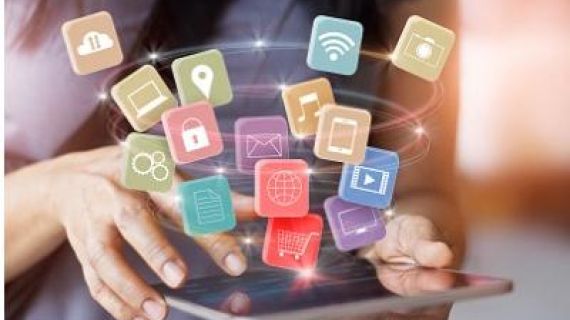 Woman using mobile device with apps floating in air above device