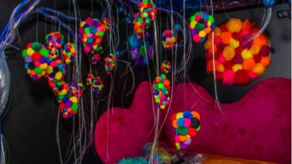 Image of a sensory room with tactile chair and hanging objects