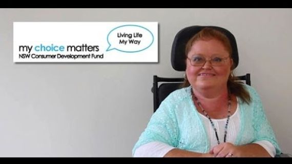 Lady sitting at table in a wheelchair