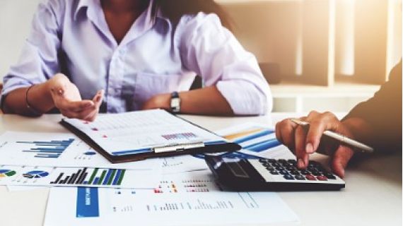 Professionals working with paper work and calculator