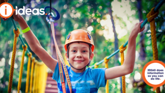 Image of boy wearing helmet on rope course