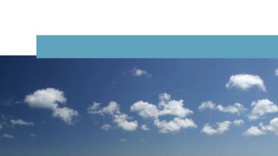 Couple sitting on a bench overlooking the beach