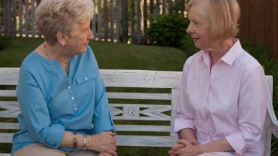 Two female neighbours sitting and chatting