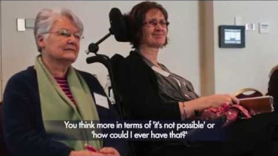 Mother sitting next to her daughter who is in a wheelchair
