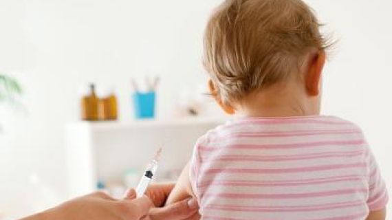 baby girl about to receive an vaccination injection