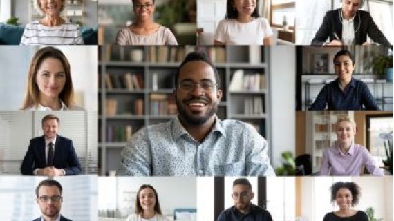 A view of a computer screen, set up for a video conference, with different ethnicity and age people engaged in group videocall.
