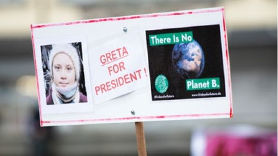Image of placcard with picture of Greta Thunberg's face, words "Greta for President" and image of the world with words "there is no Planet B"