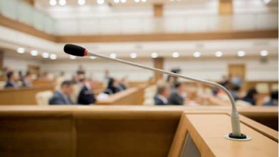 Image of a microphone at a lectern in a formal inquiry chamber
