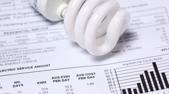 An image of a  lightbulb laying on a utility bill