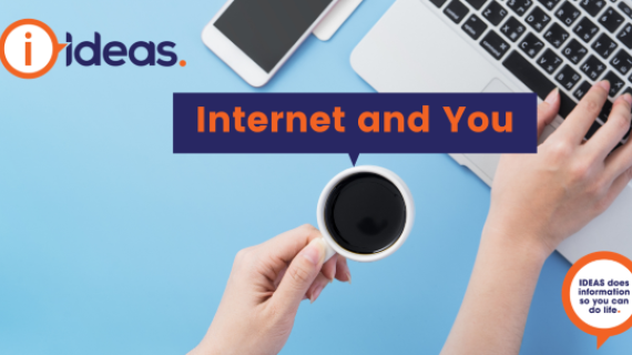 Hand holding cup of coffee over a laptop with the words internet and you above.