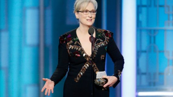 Actor Meryl Streep stands at a podium on stage at the Oscars